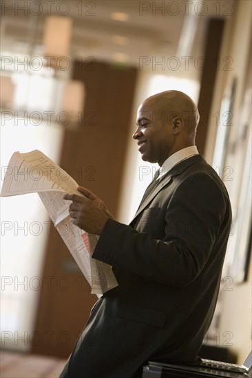 African businessman reading newspaper