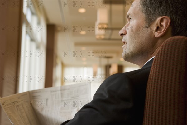 Businessman holding newspaper