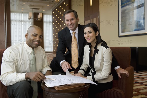 Multi-ethnic business people posing in lobby