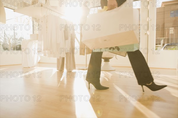Multi-ethnic women holding shopping bags in shop