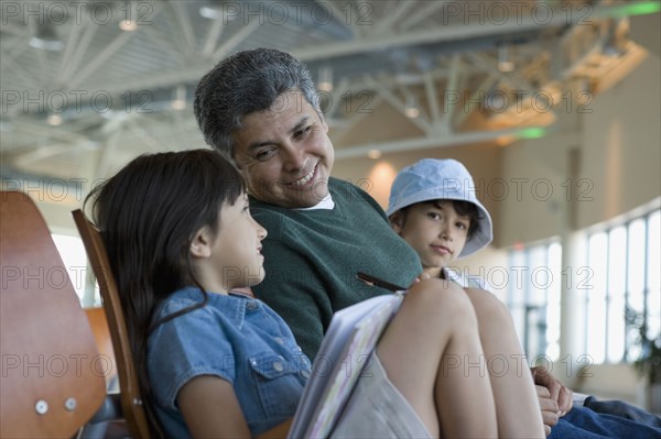 Hispanic family waiting in airport