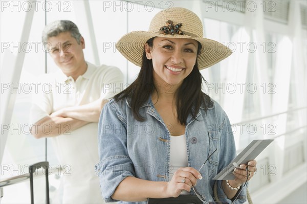 Hispanic couple waiting in airport