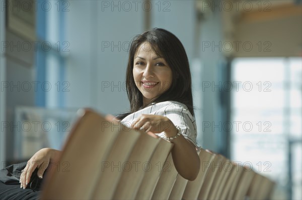 Hispanic woman waiting in airport