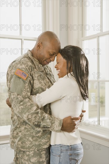 African soldier and girlfriend hugging