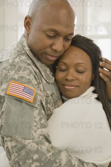 African soldier and girlfriend hugging