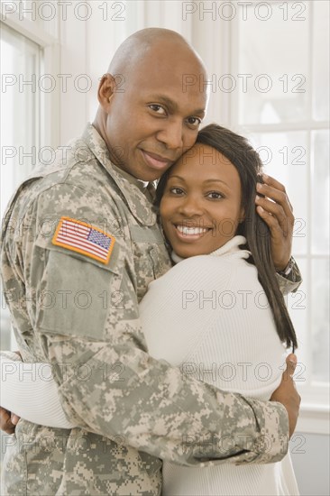 African soldier and girlfriend hugging