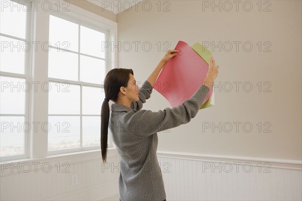 Hispanic woman holding color swatches