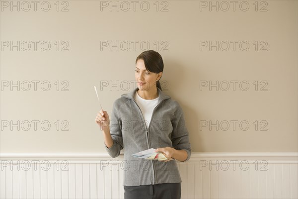 Hispanic woman holding color swatches