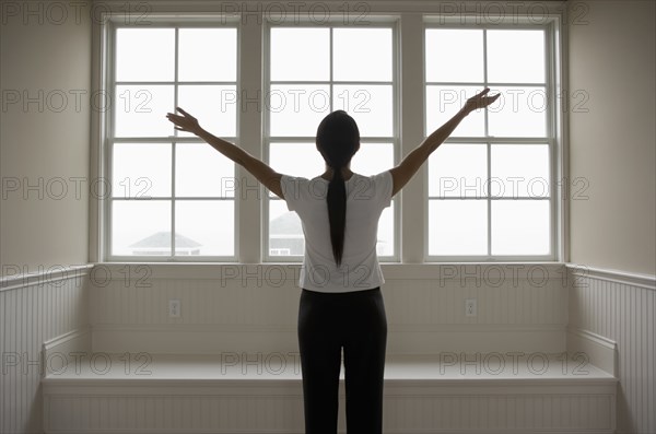 Hispanic woman with arms outstretched