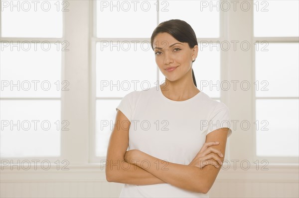 Hispanic woman with arms crossed