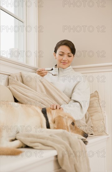 Hispanic woman petting dog