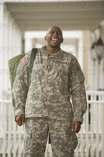 African man in military uniform laughing