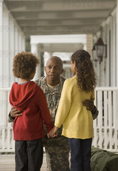 African soldier talking to son and daughter