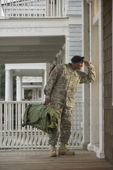 African soldier standing on front stoop
