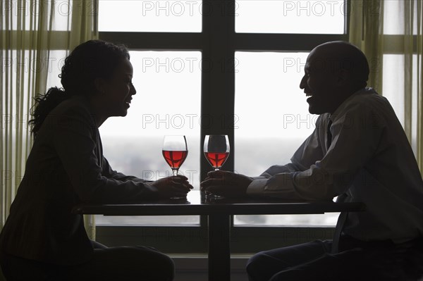 African couple drinking red wine