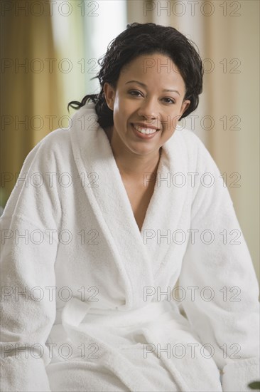 African woman smiling in bathrobe