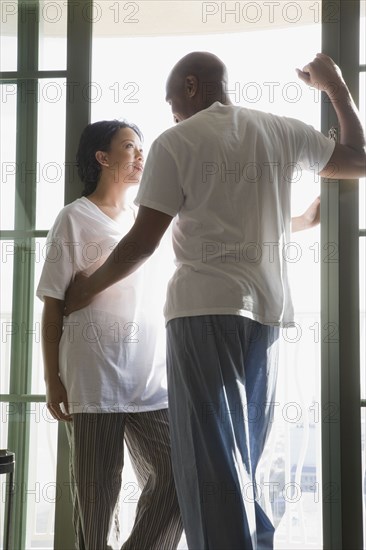 African couple in pajamas hugging