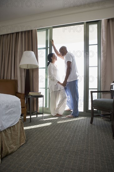 African couple in pajamas holding hands