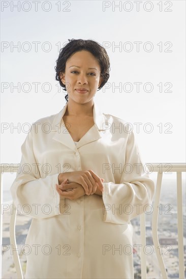 African woman standing on balcony