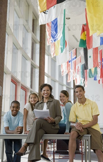 Teacher and students posing in classroom