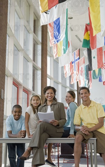 Teacher and students posing in classroom