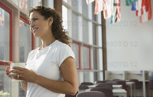 Hispanic businesswoman looking out window