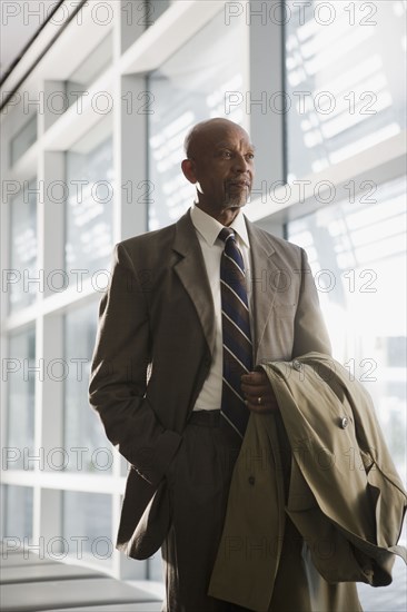 African businessman holding coat