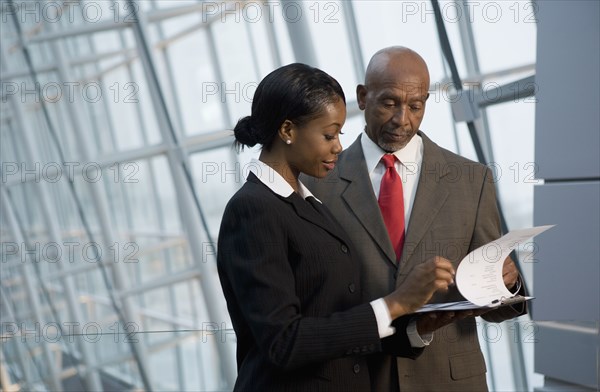 African businesspeople reviewing paperwork