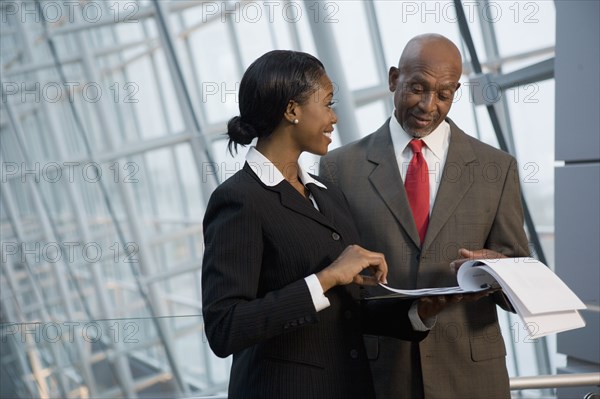 African businesspeople reviewing paperwork