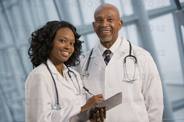 African doctors smiling with medical chart