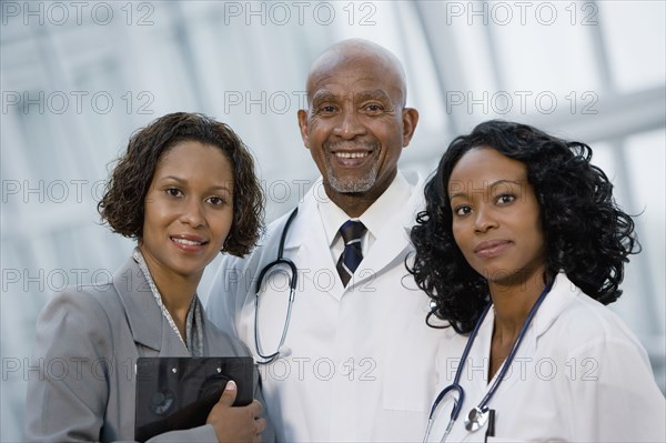 African businesswoman posing with doctors