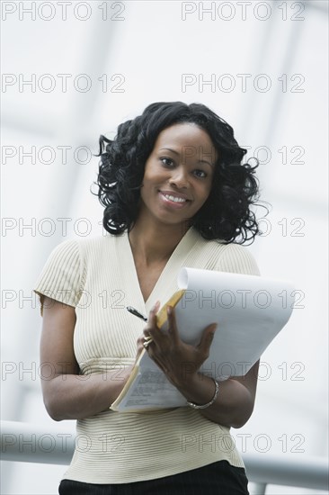 African businesswoman holding paperwork