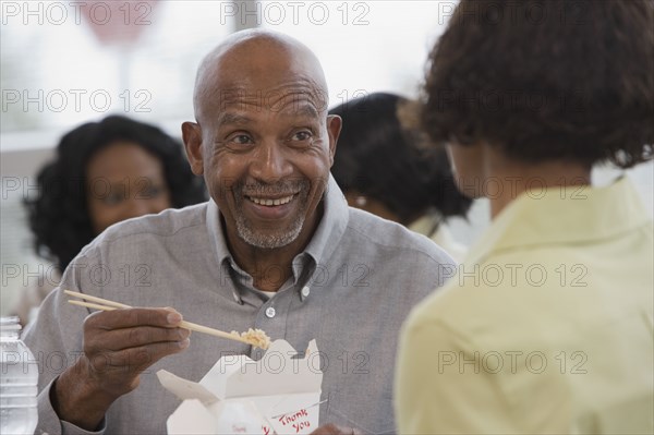 African man eating with chopsticks
