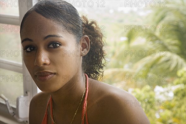 Hispanic woman sitting near window