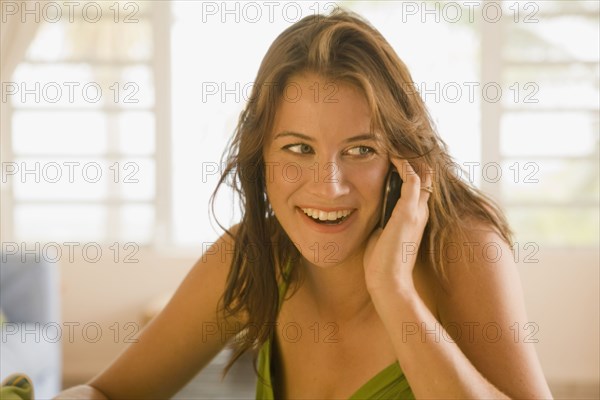 Mixed race woman talking on cell phone