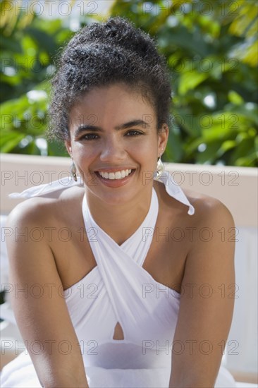 Hispanic woman sitting outdoors