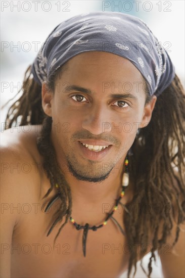 Bare chested Hispanic man in headscarf