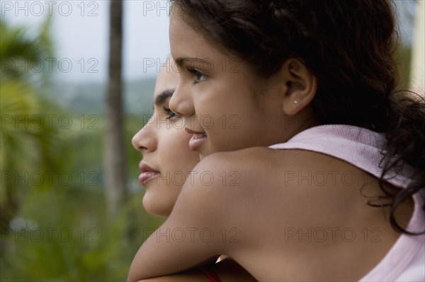 Hispanic girl hugging sister