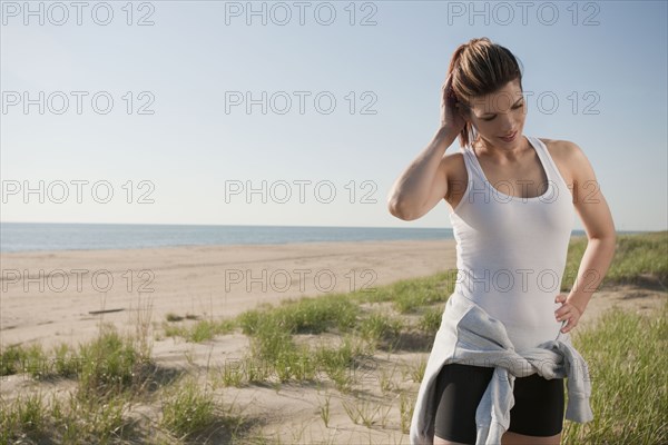 Mixed race woman in sportswear on beach