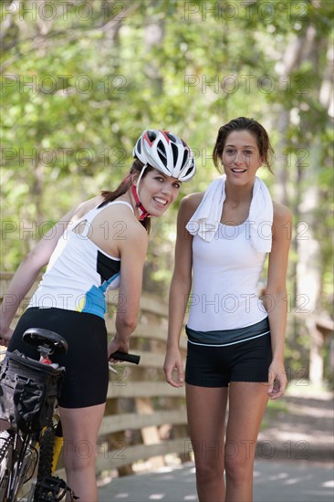 Women in sportswear standing on bridge