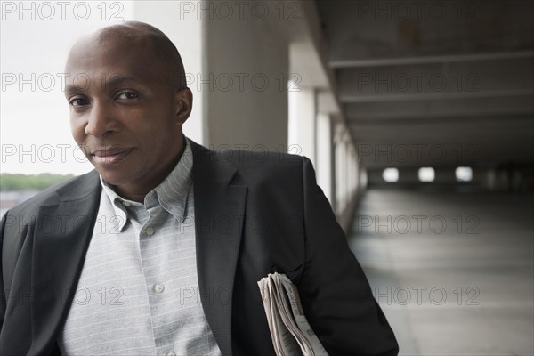 African businessman standing in parking garage