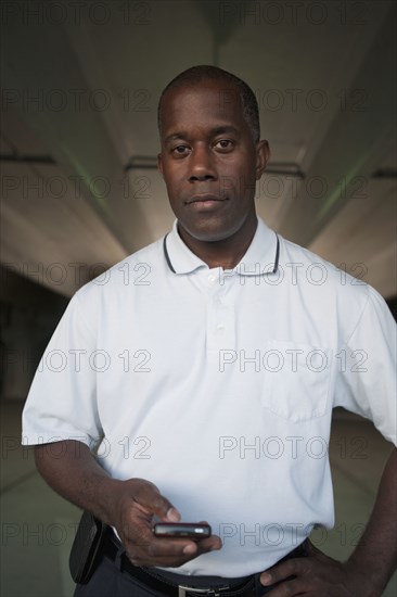 African man standing in parking garage