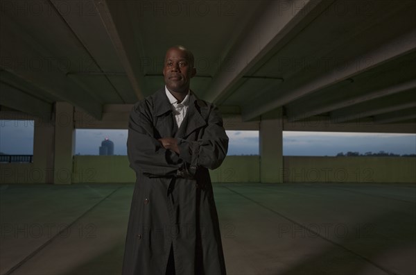 African businessman standing in parking garage