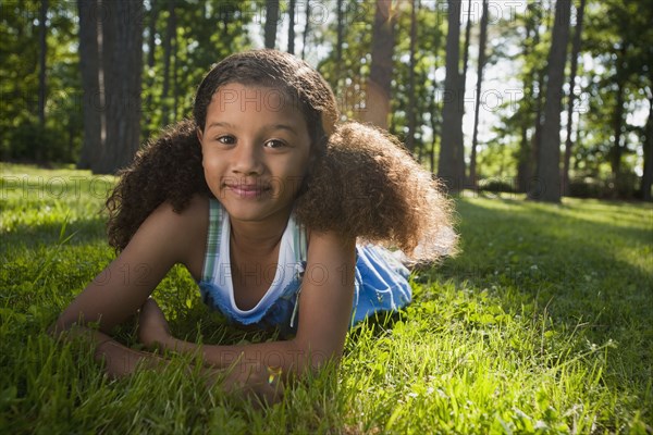 African American girl laying in grass