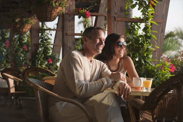 Smiling couple eating in restaurant