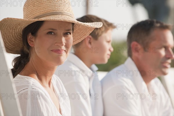 Smiling Caucasian woman sitting with family