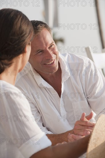 Smiling Caucasian husband and wife talking
