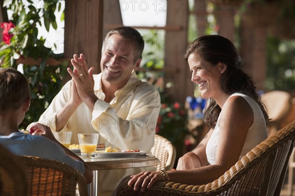 Caucasian family eating in restaurant