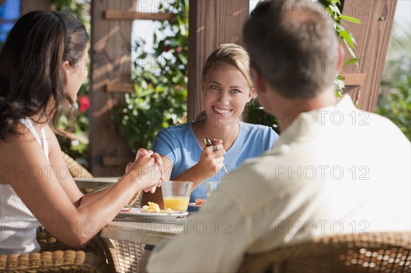 Caucasian family eating in restaurant