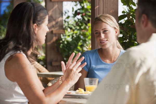 Caucasian family eating in restaurant